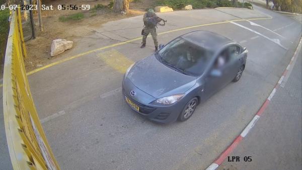 Terrorists are caught on surveillance footage killing people in a car as they tried to enter the kibbutz.